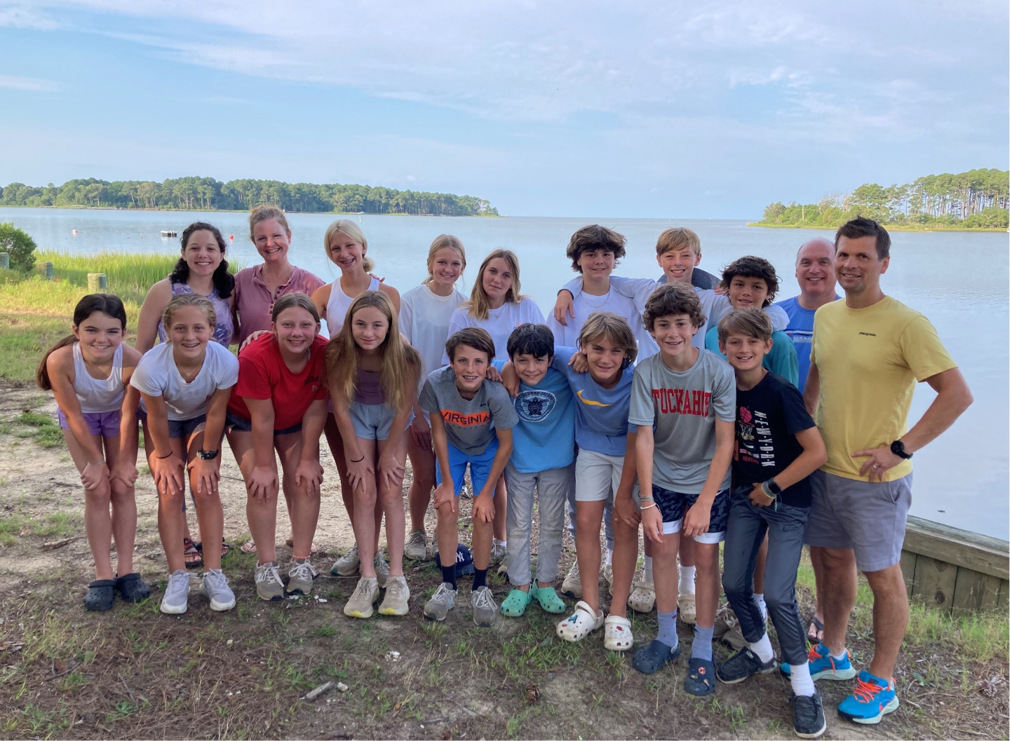Youth group posing in front of lake